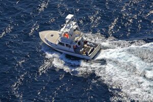 A boat is sailing through the water on the ocean.