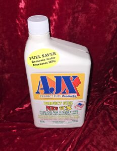 Fuel additive bottle on red fabric background.